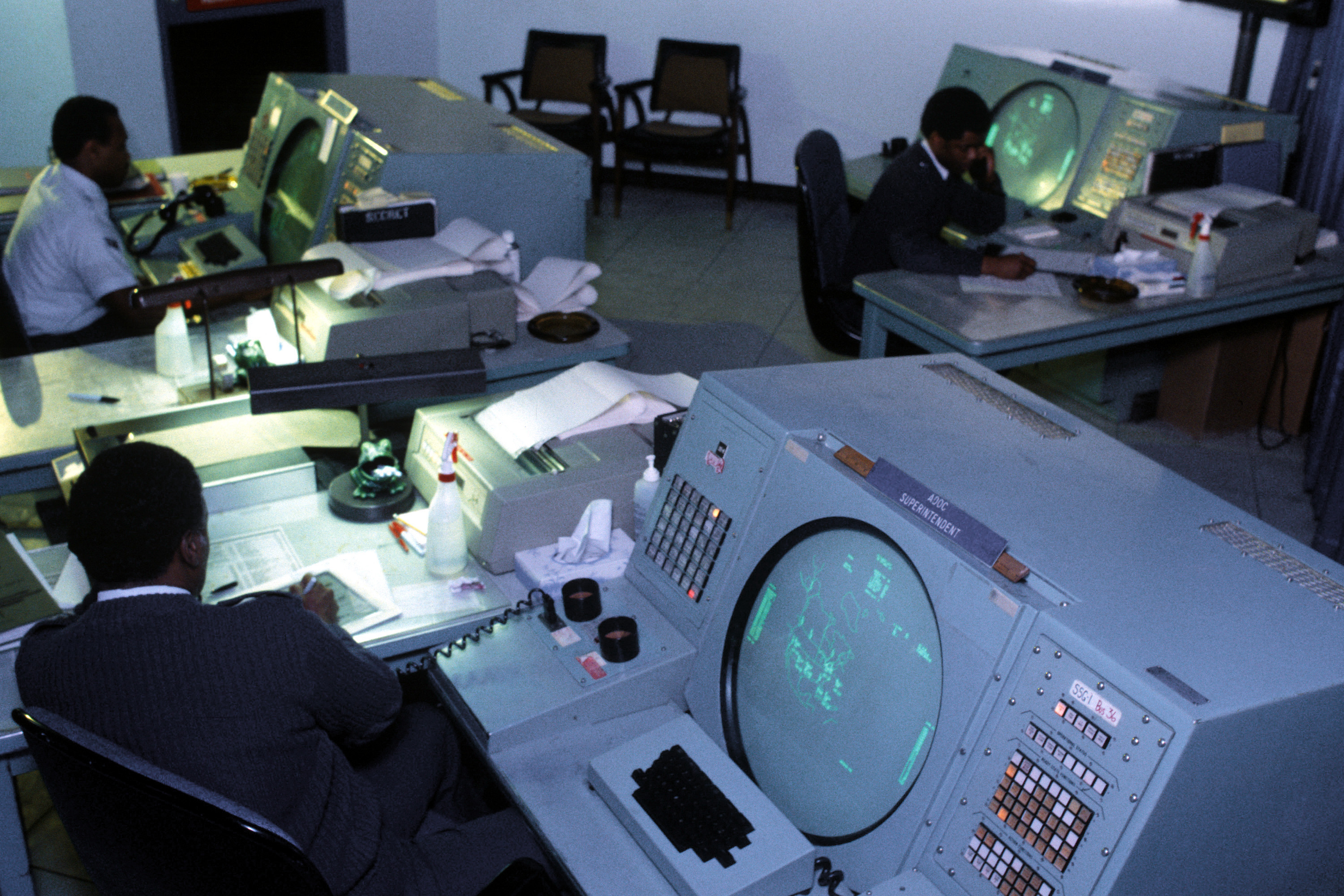 "U.S. Air Force personnel work inside the NORAD Air Defense Operations Center at Cheyenne Mountain in 1984."