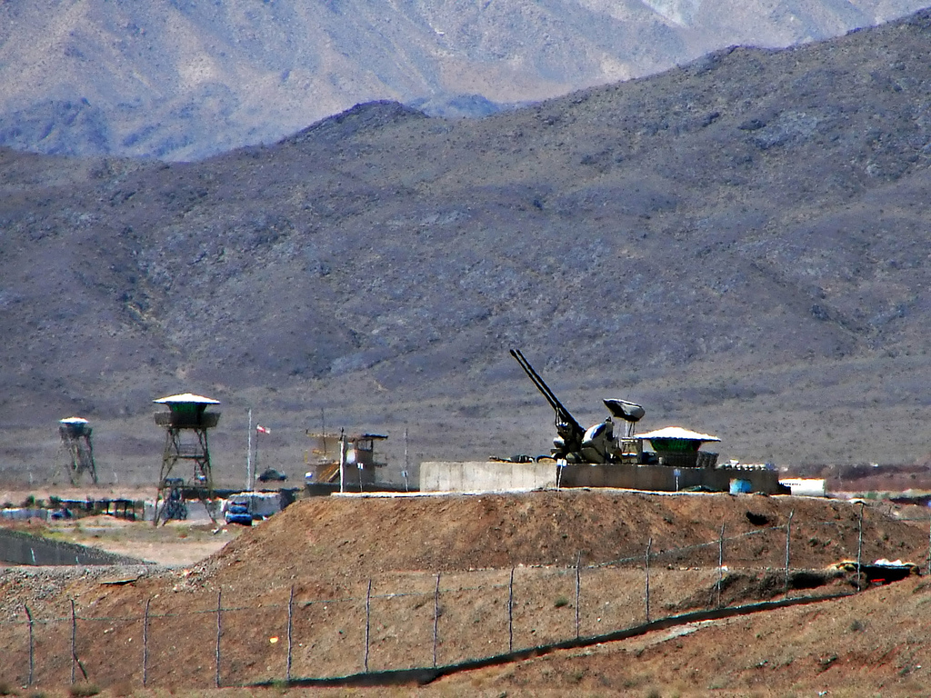 "Anti-aircraft defenses guard Iran's Natanz nuclear facility against a mountain landscape."