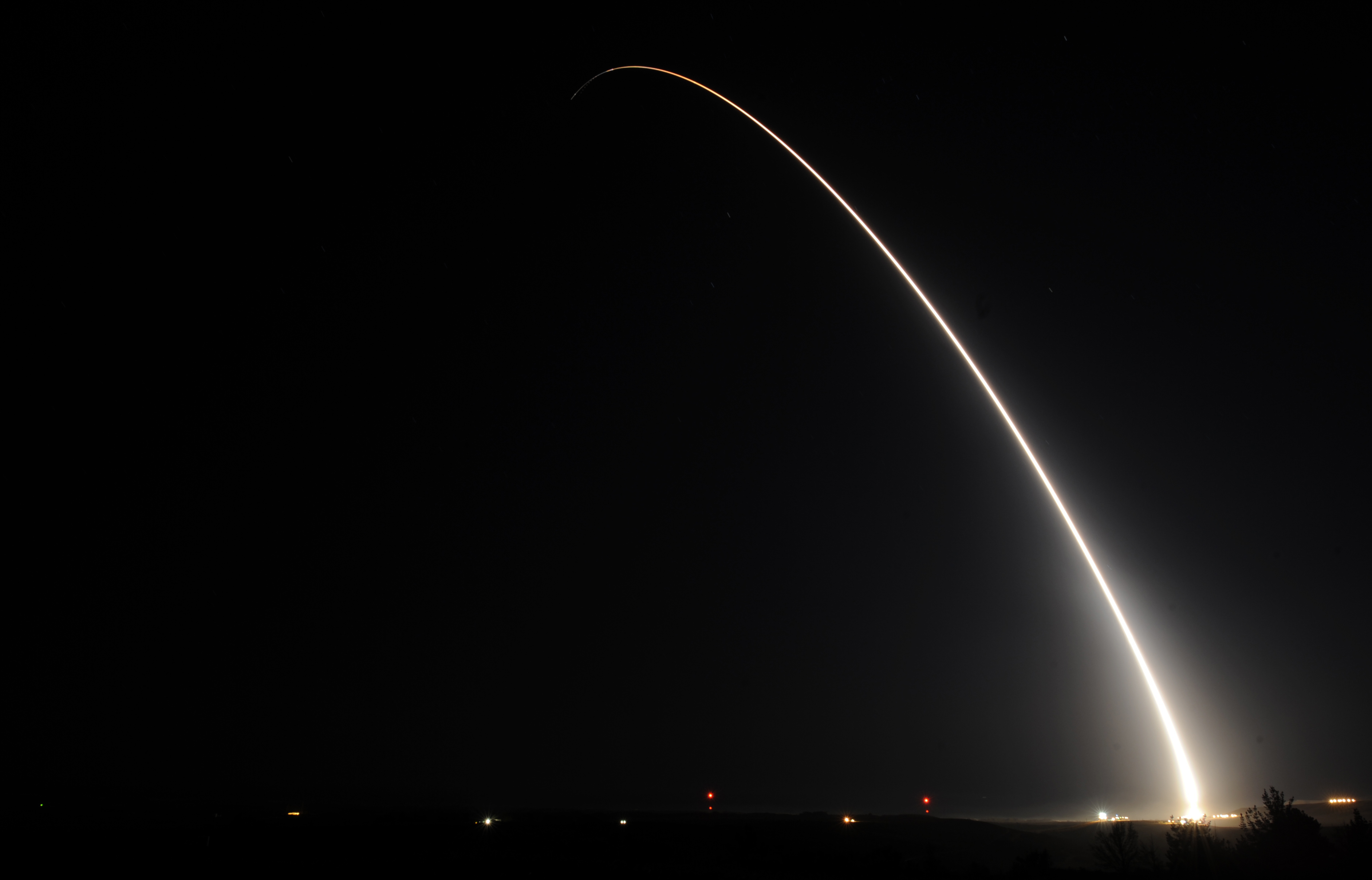 "The luminous arc of an unarmed Minuteman III missile during a nighttime operational test launch."
