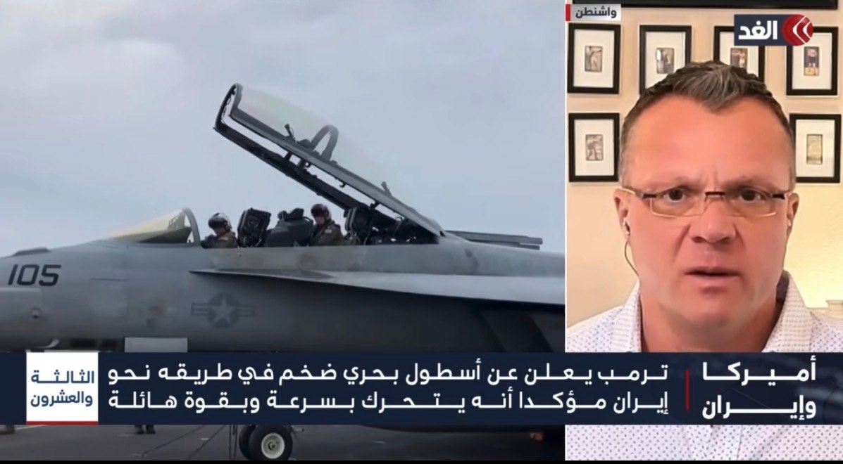 Al-Ghad broadcast showing military aircraft beside Erik E. Brown appearing from Washington.