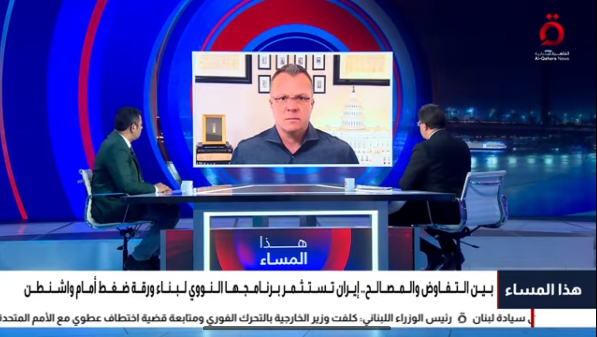 Al Qahera News studio with two anchors and Erik E. Brown appearing from Washington on the central screen.